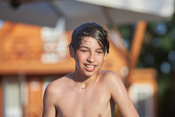 Young boy enjoying water activities at the beach © justoomm
