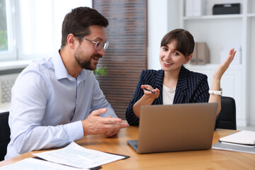Consultant working with client at table in office. Business meeting