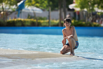 Boy enjoys summer fun at water park © justoomm