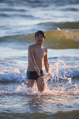 Boy enjoys a sunny day at the beach © justoomm