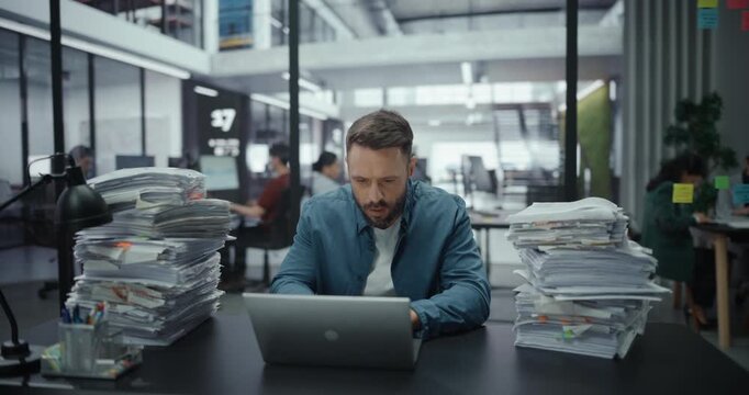 Overworked Frustrated Office Worker Using Laptop, Writing a Financial Report, Trying to Make It Before a Deadline. Tired Exhausted Businessman Working on a Computer Behind His Desk