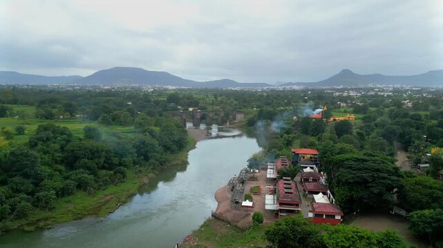 smoke coming out by cremation centre near at Krishna river satara drone view
