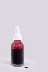 Exfoliating serum packaging with liquid drop, minimalist vertical composition, copy space.