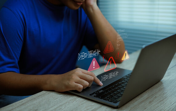 System error warning on laptop with stressed man, concept of data breach, cyber attack, malware infection, online fraud, and information security risk in digital technology environment