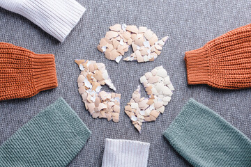 Recycled clothing and sustainable fashion concept with autumn woolen sweater sleeves. Eco-friendly textile reuse, reducing waste, and promoting ecological lifestyle. top view
