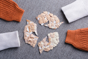 Recycled clothing and sustainable fashion concept with autumn woolen sweater sleeves. Eco-friendly textile reuse, reducing waste, and promoting ecological lifestyle. top view
