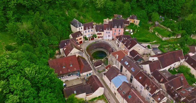 Aerial view of ancient town of Tonnerre with unusual water reservoir Fosse Dionne. Burgundy France
