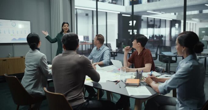 Montage of Diverse Business Professionals in a Conference Room, Collaborating on Ideas Around a Table. Footage Shows Teamwork in Progress, Ending with Colleagues Smiling as They Reach a Solution
