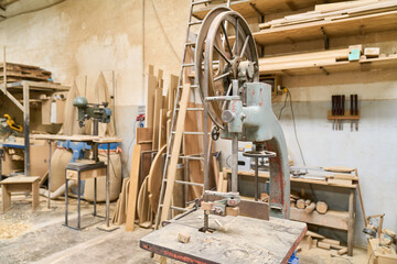 Old woodworking machine in a well-organized lumber workshop