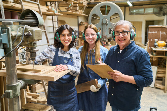 Teamwork in a bustling lumberyard with diverse staff members