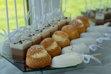 Candy bar with  with macaroons, different sweets and cupcakes. Wedding buffet.