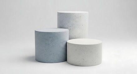 Three cylindrical pedestals of varying heights and subtle colors arranged on a clean white background for product display