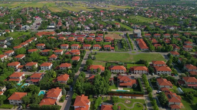 Rural settlement of a residence village filmed from drone  summer season. Luxury villa neighborhood in Ilfov, Romania