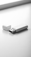 Fototapeta premium A high-angle, close-up view of a modern, white USB flash drive resting on a plain, bright white surface.