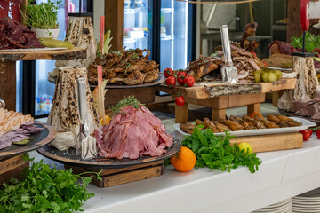 Obraz premium Platter of antipasti and appetizers. Mix of dried meat Jerky . From chicken , beef and pork. wine snacks. Luxury hotel open buffet with a wide variety of meats. Lamb kebab