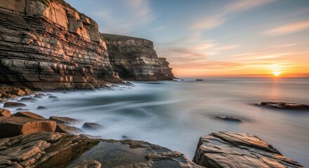 Dramatic Sunset Over Rugged Coastal Cliffs and Ocean Waves