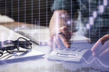 Business meeting with documents and graphs on desk