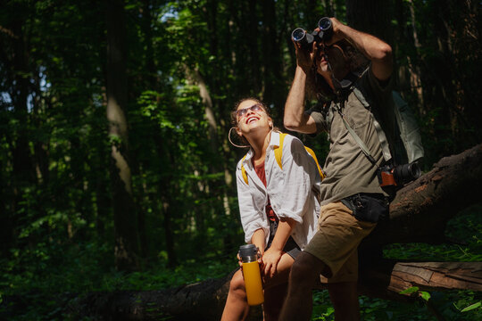 Beautiful young couple relaxing after hiking and taking a break - Powered by Adobe