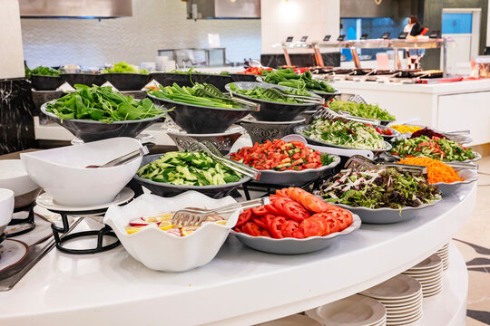 Mediterranean cuisine, olive oil, healthy and delicious salad varieties with green vegetables.Vegetarian and vegan healty food, open buffet in a luxury hotel. Meze varieties, salad bar. - Powered by Adobe