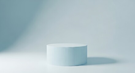 Minimalist light blue cylindrical podium with ribbed texture, casting a soft shadow on a clean white background