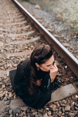 Woman in Historical Outfit Lying on Railway Tracks