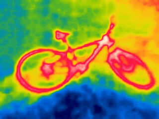 Ornange bike on a blue field. Image from thermal imager device.