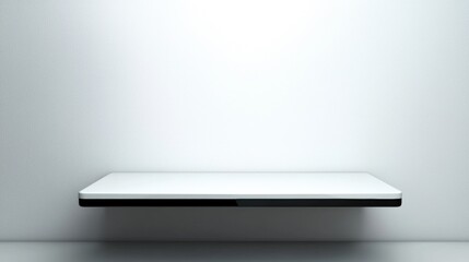 A white shelf with a black base against a white wall.