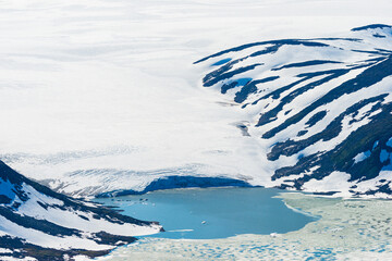 Majestic Blåmannsisen glacier with serene lake and rugged mountains in Norway