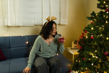 Woman blowing off a candle at the end of a christmas celebration in her home