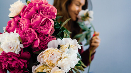 Woman Smelling Bouquet of Peonies
