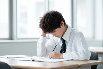 Student in despair while taking an exam in the classroom today