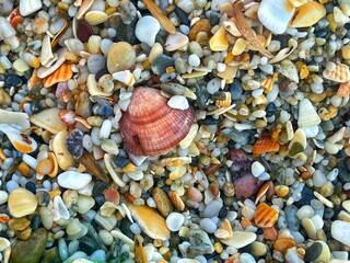 Glass pebble beach sunset. A beautiful beach of and sea shells sea glass made of tumbled glass polished over time by the waves of the ocean into shining pebbles
