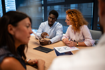 Diverse business team discussing strategy during office meeting