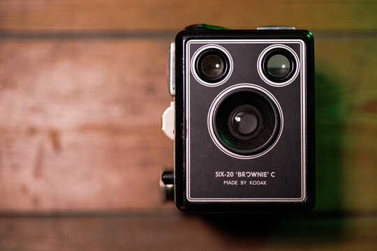 Close-up of a vintage Kodak Six-20 Brownie C box camera on a wooden surface