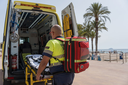 Paramedic is preparing to assist someone on a tropical beach