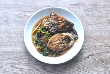 spicy deep fried chop Nile Tilapia or mango fish slice ginger and ear mushroom couple celery dressing soy sauce on plate 