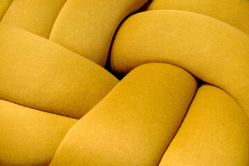 Paris, France. Yellow and blue toned decorative itmes. Soft fabric woven in to knot shape.