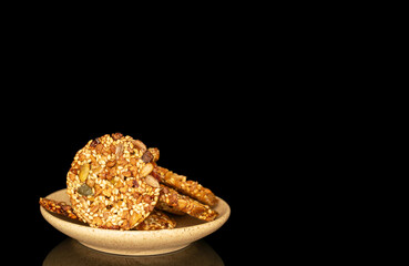 Thaler cookies with nuts and honey isolated on black background, close-up.