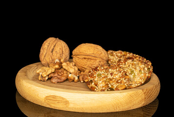 Thaler cookies with nuts and honey isolated on black background, close-up.