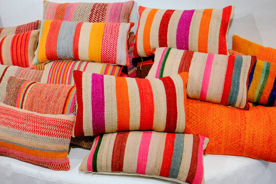 Paris, France.  Europe.  Colorful collection of South American woven pillows