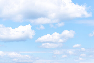 Blue sky with fluffy white summer clouds