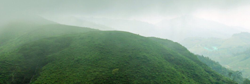 Mountain landscape with fog Beautiful view of Parunthumpara mountains Idukki, Kerala, India
