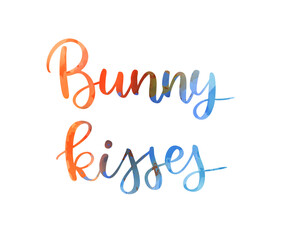 Bunny kisses - colorful watercolor handwritten modern calligraphy text. Easter holiday concept