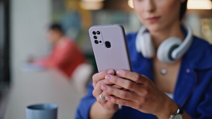 Lady hands texting cellphone in contemporary cafeteria closeup. Smiling woman