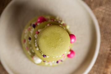 French Christmas tree macaroons in a plate on a table. Merry Christmas and Happy New Year. Top view.