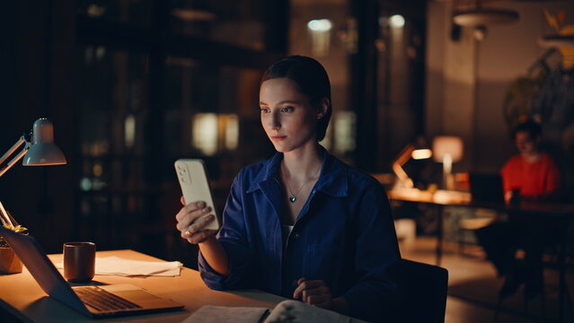 Employee reading sms night workspace closeup. Smiling woman freelancer shopping