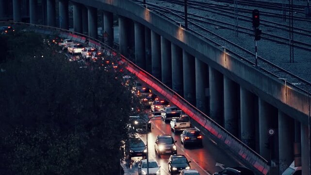 Nighttime urban traffic jam underpass with lit railway tracks in Skopje, Macedonia