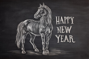 A drawing of a horse in white chalk on a black chalkboard with the words "Happy New Year" written on it
