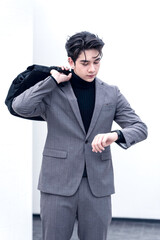 Stylish businessman walking with a briefcase in an urban outdoor setting. A variety of businessmen's gestures.
