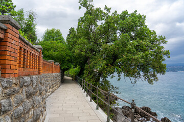 Stone seaside path Lungomare with railing along Adriatic coast in Opatija, Croatia